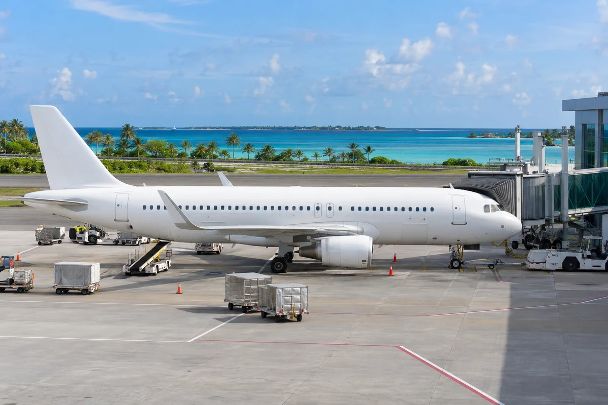 Illustrative scheduled passenger aircraft at a terminal jet bridge
